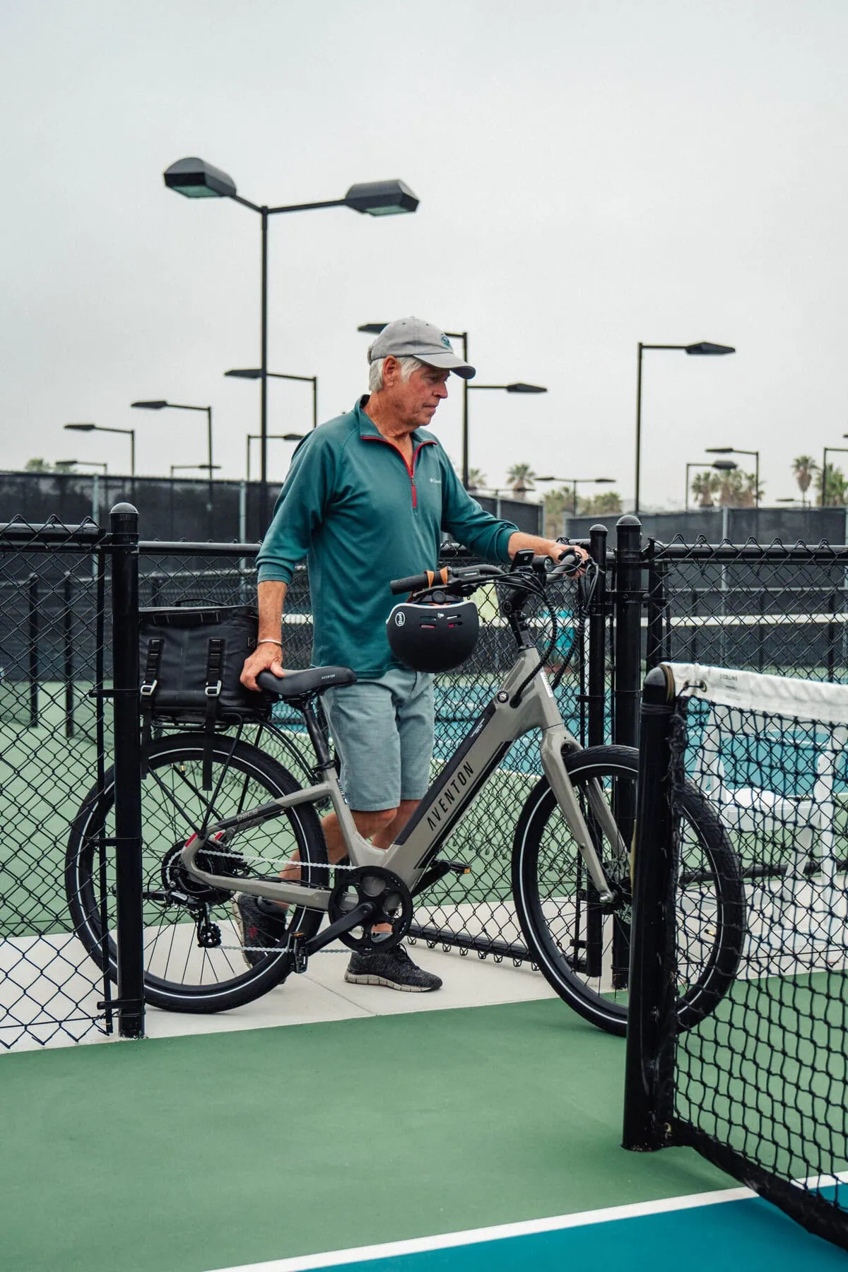 a man standing next to a e-bike