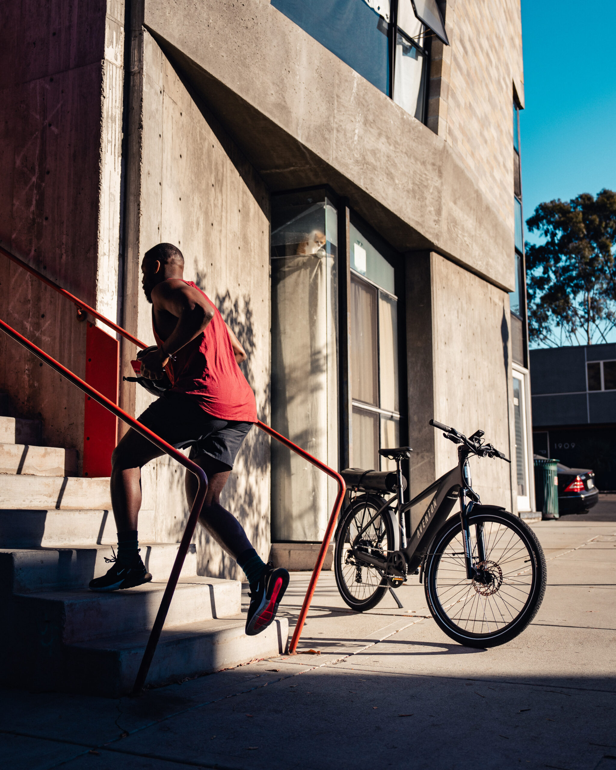 a man climbing a staircase with an e-bike