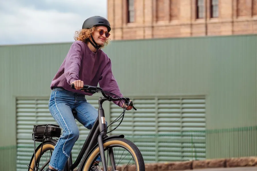 a woman riding a e-bike