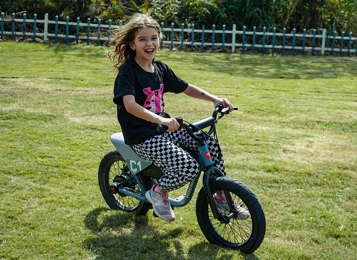 a girl riding a small e-bike