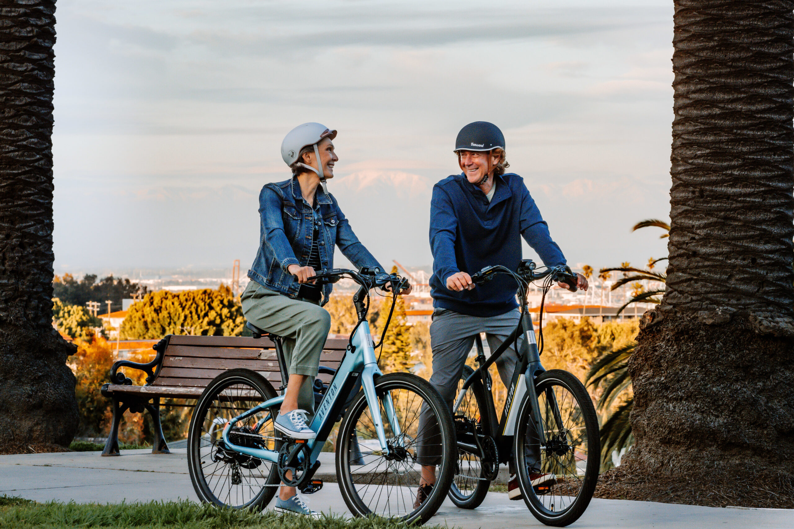 a man and woman on e-bicycles
