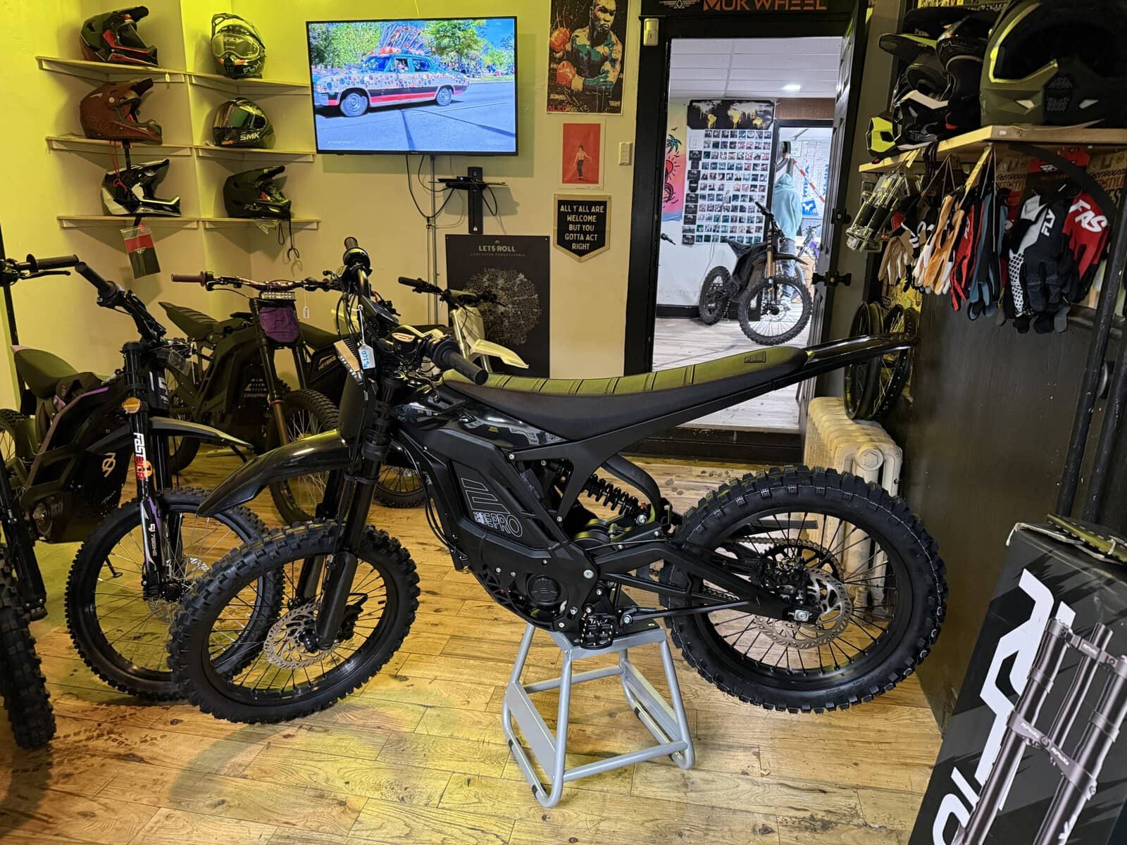 Let's Roll Lancaster shop floor with E Ride Pro electric dirt bikes and riding gear display