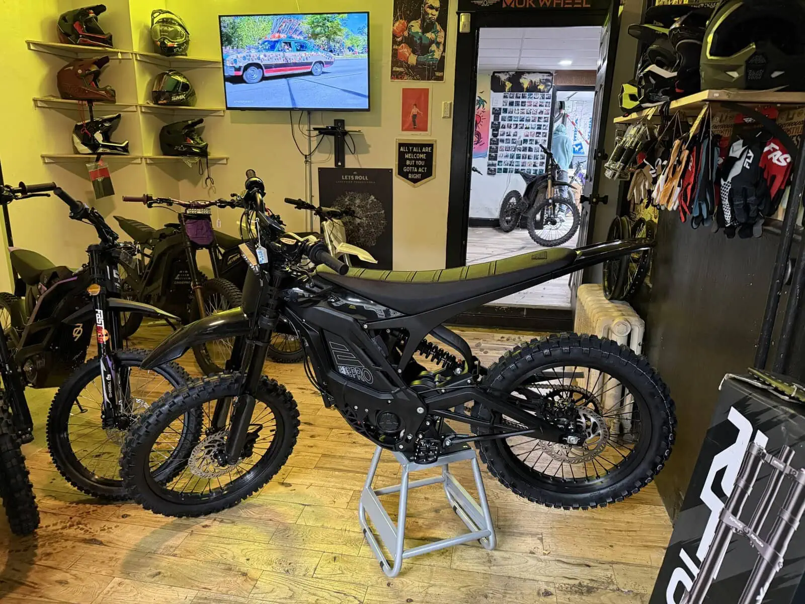 Let's Roll Lancaster shop floor with E Ride Pro electric dirt bikes and riding gear display