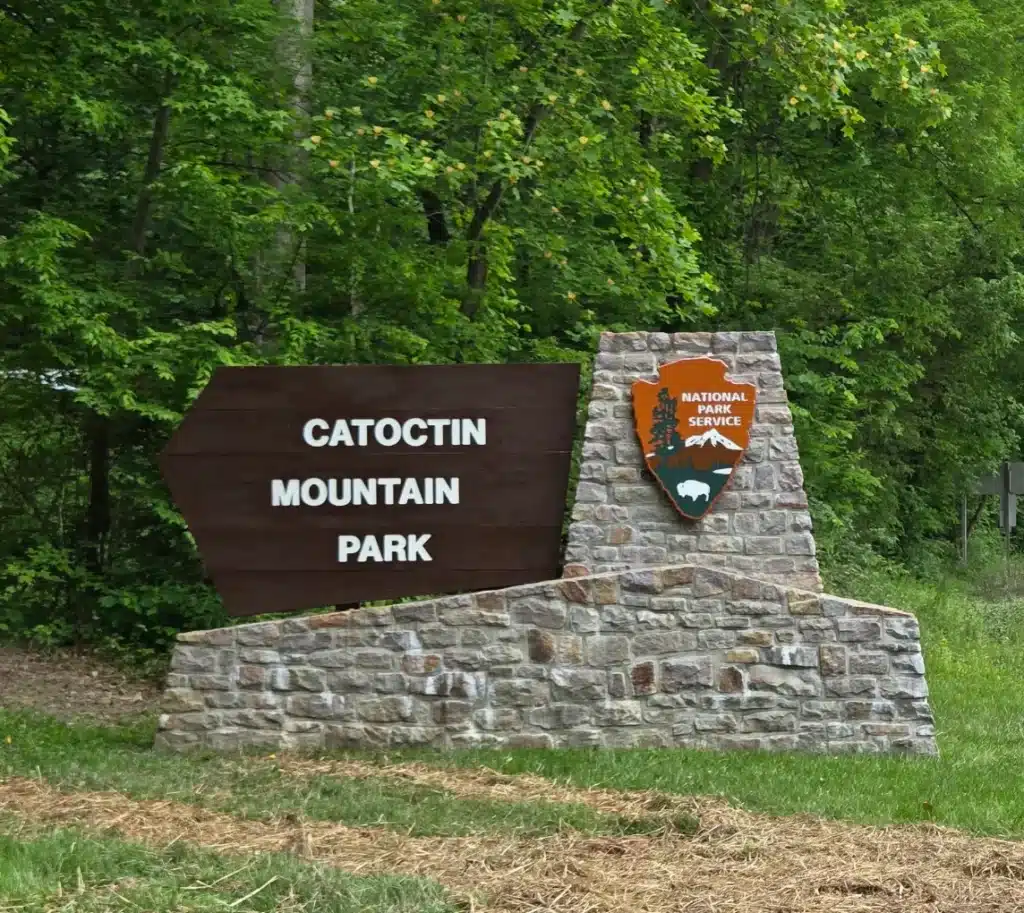 Stone entrance sign for Catoctin Mountain Park with the National Park Service arrowhead emblem
